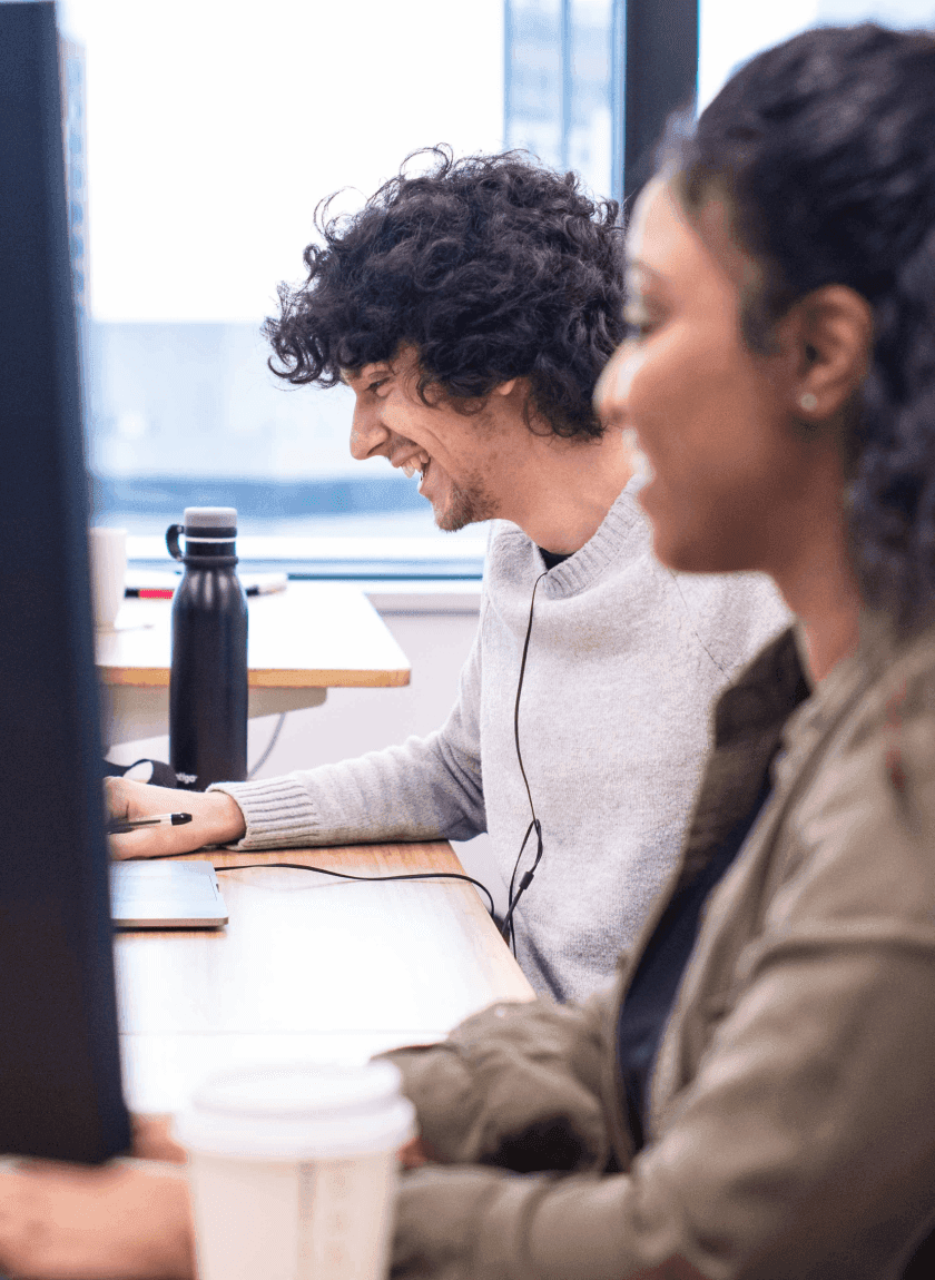 Two employees laughing at work